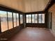 Bright enclosed patio with brick accents, lots of windows, and a ceiling fan, ideal for lounging at 9679 W Cinnabar Ave # B, Peoria, AZ 85345