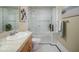 Clean bathroom featuring a shower/tub combo, a white vanity, and classic black and white tiled floor at 114 W Adams St # 907, Phoenix, AZ 85003
