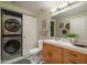 Full bathroom contains modern lighting and a washer/dryer combination at 114 W Adams St # 907, Phoenix, AZ 85003