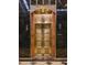 Close-up of brass art deco elevator doors with inlaid marble walls at 114 W Adams St # 907, Phoenix, AZ 85003