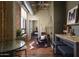 Bright living area featuring industrial ceiling details, rustic wooden floors, and comfortable seating at 114 W Adams St # 907, Phoenix, AZ 85003