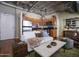 Open-concept living room and kitchen with exposed ceilings, wood floors, and neutral colors at 114 W Adams St # 907, Phoenix, AZ 85003