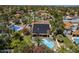View of backyard, home, and solar panels with lush landscaping and inviting pool area at 12537 N 76Th Pl, Scottsdale, AZ 85260