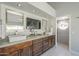 Vanity with granite countertop, double sinks, and dark cabinets at 12537 N 76Th Pl, Scottsdale, AZ 85260