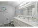 Clean bathroom with dual sinks, quartz countertops, and a decorative mirror at 12537 N 76Th Pl, Scottsdale, AZ 85260