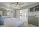 Bedroom with a bed, mirrored closet, tv, ceiling fan, and a view of the backyard at 12537 N 76Th Pl, Scottsdale, AZ 85260
