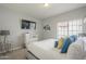 Bright bedroom featuring a large window, soft carpet, and mounted TV at 12537 N 76Th Pl, Scottsdale, AZ 85260
