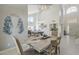 Bright dining room with modern light fixture, pool table, and open layout to the rest of the home at 12537 N 76Th Pl, Scottsdale, AZ 85260