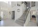 Elegant foyer featuring a staircase with glass railings, high ceilings, and modern decor at 12537 N 76Th Pl, Scottsdale, AZ 85260