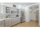Modern kitchen with stainless steel appliances, white countertops, tile backsplash, and gray cabinets at 12537 N 76Th Pl, Scottsdale, AZ 85260