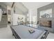 Beautiful living room with a vaulted ceiling, fireplace, and a pool table at 12537 N 76Th Pl, Scottsdale, AZ 85260