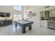 Entertaining living room with a pool table, dry bar, and modern decor at 12537 N 76Th Pl, Scottsdale, AZ 85260