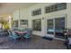Covered outdoor patio with dining area and view of the sparkling pool through sliding glass doors at 12537 N 76Th Pl, Scottsdale, AZ 85260
