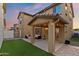 Backyard featuring a covered patio with string lights and artificial turf at 1255 N Banning --, Mesa, AZ 85205