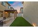 Backyard featuring a covered patio with a gas fire pit and artificial turf at 1255 N Banning --, Mesa, AZ 85205