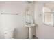Well-lit powder room featuring a pedestal sink, oval mirror and a window with adjustable blinds at 1255 N Banning --, Mesa, AZ 85205