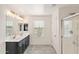 Bright bathroom features a double sink vanity, glass-enclosed shower, and tiled floors at 1255 N Banning --, Mesa, AZ 85205