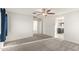 Bright bedroom features neutral carpet, ceiling fan, and doorways to the en suite and another room at 1255 N Banning --, Mesa, AZ 85205