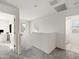 Upstairs hallway with neutral carpet leading to a laundry room and office space at 1255 N Banning --, Mesa, AZ 85205