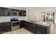 Beautiful kitchen with stainless steel appliances, granite counters, and stylish dark cabinetry at 1255 N Banning --, Mesa, AZ 85205
