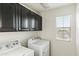 Laundry room featuring upper cabinets and a white washer and dryer set at 1255 N Banning --, Mesa, AZ 85205