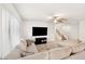 Bright living room featuring a plush sofa, ceiling fan, and media center, ideal for relaxation at 1255 N Banning --, Mesa, AZ 85205