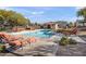 Community pool featuring lounge chairs and shade trees at 1255 N Banning --, Mesa, AZ 85205