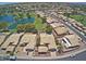 Stunning aerial view of the neighborhood featuring homes, a golf course, and a scenic lake at 14300 W Bell Rd # 261, Surprise, AZ 85374