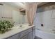Bathroom featuring a vanity, framed mirror, and shower-tub combination at 14300 W Bell Rd # 261, Surprise, AZ 85374
