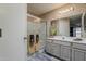 Bathroom with a vanity, shower stall, and patterned wallpaper at 14300 W Bell Rd # 261, Surprise, AZ 85374