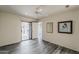 Sunlit bedroom with ceiling fan and sliding doors to the patio at 14300 W Bell Rd # 261, Surprise, AZ 85374