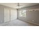 Bedroom with neutral walls, plush carpet, a window, and a mirrored closet at 14300 W Bell Rd # 261, Surprise, AZ 85374