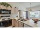 Kitchen featuring white appliances, and decoratively tiled backsplash at 14300 W Bell Rd # 261, Surprise, AZ 85374