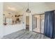 Bright kitchen with vaulted ceilings, breakfast bar, white appliances, and sliding doors to patio at 14300 W Bell Rd # 261, Surprise, AZ 85374