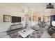 Bright living room with modern decor, a ceiling fan, and an open view into the kitchen area at 14300 W Bell Rd # 261, Surprise, AZ 85374