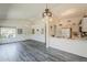 Open floor plan featuring vaulted ceilings, a breakfast bar, modern wood flooring and a ceiling fan at 14300 W Bell Rd # 261, Surprise, AZ 85374