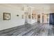 Bright living room boasts vaulted ceilings, a ceiling fan, and modern gray wood flooring at 14300 W Bell Rd # 261, Surprise, AZ 85374