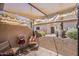 Cozy covered patio with shade cover, potted flowers, and privacy wall at 14300 W Bell Rd # 261, Surprise, AZ 85374