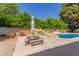 Backyard includes a pool with waterfall, picnic table, and patio at 14828 N Skokie Ct, Phoenix, AZ 85022