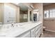 Bathroom with double sink vanity, large mirror and shower/tub combination at 14828 N Skokie Ct, Phoenix, AZ 85022