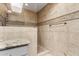 Bathroom shower with neutral tiled walls and towel bar at 14828 N Skokie Ct, Phoenix, AZ 85022