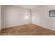 Neutral bedroom features tan carpet, white walls, and closet with hanging pendant lighting at 14828 N Skokie Ct, Phoenix, AZ 85022