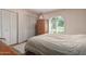 Bedroom features carpet, large window with shutters and closet at 14828 N Skokie Ct, Phoenix, AZ 85022