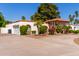 Single-story home featuring a circular driveway, two-car garage and mature landscaping at 14828 N Skokie Ct, Phoenix, AZ 85022