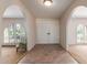 Bright entryway showcasing arched doorways, tile flooring, and double front doors at 14828 N Skokie Ct, Phoenix, AZ 85022