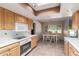 Kitchen with modern appliances, skylight, and adjacent dining area at 14828 N Skokie Ct, Phoenix, AZ 85022