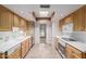 Bright kitchen with modern appliances, skylight, and tile flooring at 14828 N Skokie Ct, Phoenix, AZ 85022