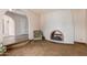 Cozy living room showcasing arched doorways, a red brick fireplace, and classic armchair at 14828 N Skokie Ct, Phoenix, AZ 85022
