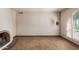 Inviting living room with a red brick fireplace, neutral carpet, and shuttered arched window at 14828 N Skokie Ct, Phoenix, AZ 85022