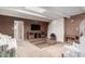 Unique living room with a sunken carpeted area, wood paneling, and a whitewashed brick fireplace at 14828 N Skokie Ct, Phoenix, AZ 85022